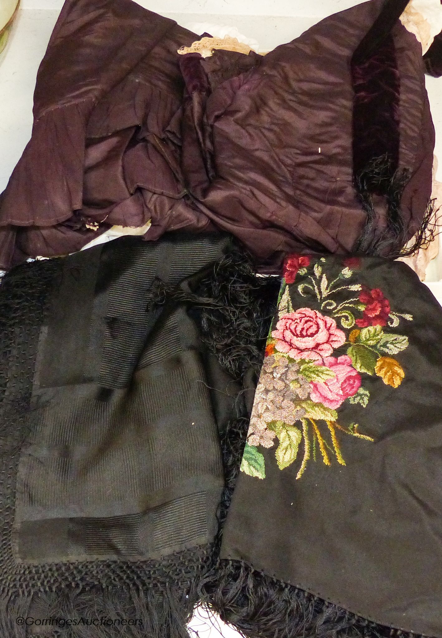 A Victorian black silk jacket and skirt, a child's white lawn dress, a black silk fringed petite point shawl and a fine silk shawl etc